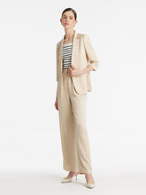 A lady wears a one-button blazer.
